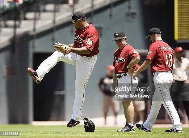 Carlos Lee of the Houston Astros kicks the glove of pitcher Chris Sampson during warm ups before the Pittsburgh Pirates and Houston Astros baseball...