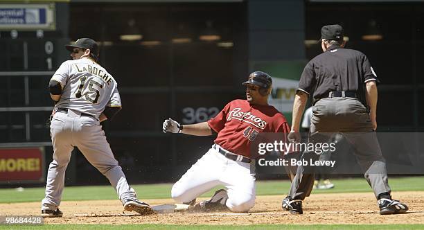 Carlos Lee of the Houston Astros watches the ball get past third baseman Andy LaRoche of the Pittsburgh Pirates after he was safe at third on a...