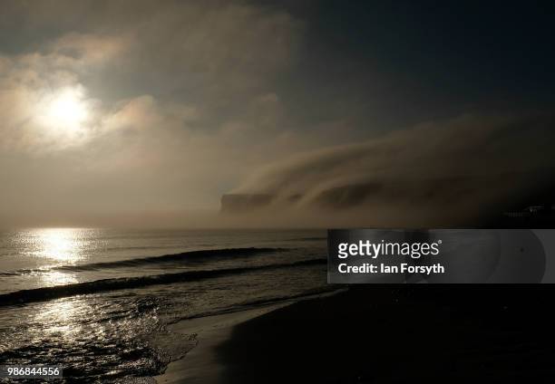Sea fog and low cloud shroud cliffs on June 29, 2018 in Saltburn-By-The-Sea, England. Low cloud and sea fog will cover many areas along the East...
