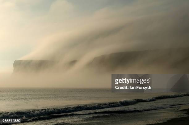 Sea fog and low cloud shroud cliffs on June 29, 2018 in Saltburn-By-The-Sea, England. Low cloud and sea fog will cover many areas along the East...