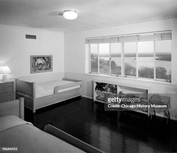 Interior view of the children's room with two twin sized beds and a large window, in the James J. Schramm residence, located on a bluff over looking...