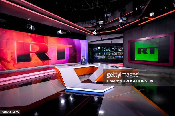 Picture taken on June 8, 2018 shows an unidentified anchor of the Russia Today TV company as he prepares to go on the air in their studio in Moscow.