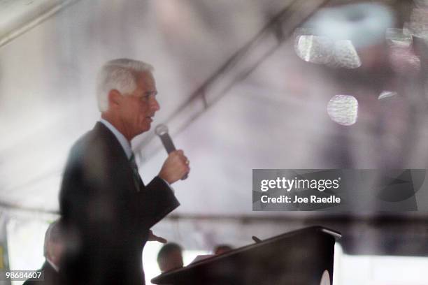 Florida Governor Charlie Crist ,seen through a plastic sheet for protection if it rained, speaks during the 826/836 Interchange Project Dedication...