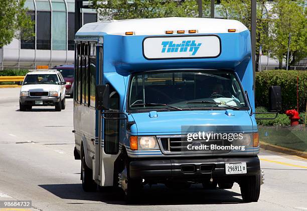 Thrifty shuttle bus drives through O'Hare International Airport in Chicago, Illinois, U.S., on Monday, April 26, 2010. Hertz Global Holdings Inc.,...