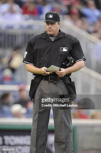 Umpire Paul Emmel looks on during a baseball game between the Washington Nationals and the Colorado Rockies on April 22, 2010 at Nationals Park in...