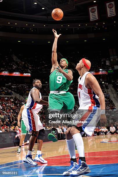 Rajon Rondo of the Boston Celtics goes up for a shot between Jason Maxiell and Charlie Villanueva of the Detroit Pistons during the game on March 2,...