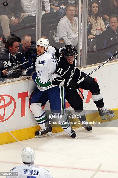 Andrew Alberts of the Vancouver Canucks is checked by Anze Kopitar of the Los Angeles Kings in Game Six of the Western Conference Quarterfinals...