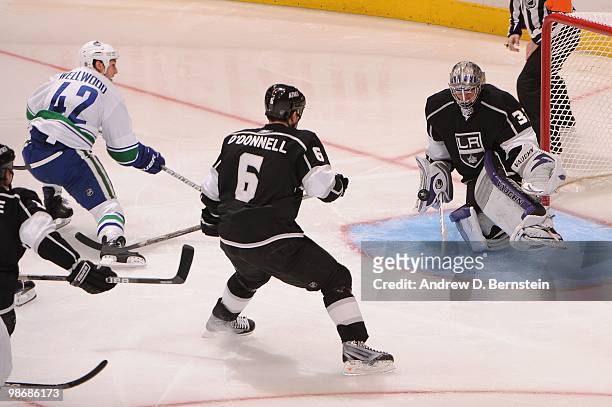 Jonathan Quick of the Los Angeles Kings makes the save against Kyle Wellwood of the Vancouver Canucks in Game Six of the Western Conference...