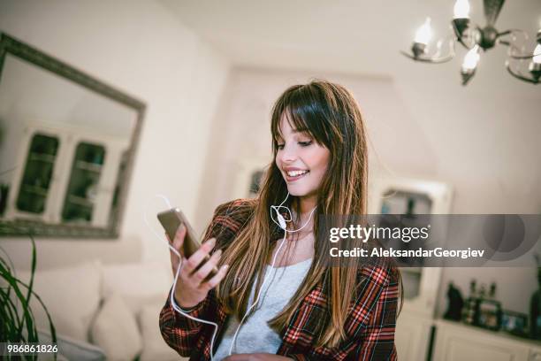 attractive female establishing video call on smartphone - the soundtrack of my life stock pictures, royalty-free photos & images