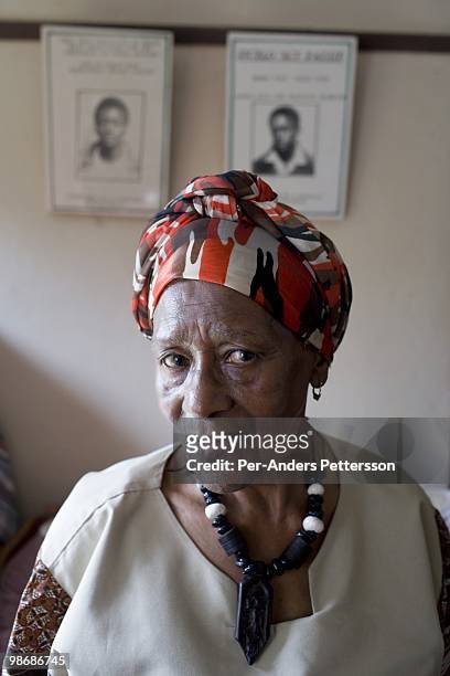 Nothembe Fazze, age 81, stands in front of a portrait of her killed sons on March 9 in her house in Duncan Village a poor township outside East...