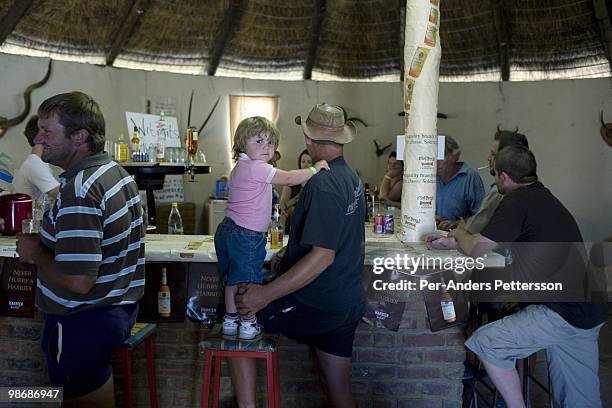 White Afrikaners drink in a bar on March 13, 2009 in Philippolis, in the Free state province, South Africa. The village is one of the oldest...