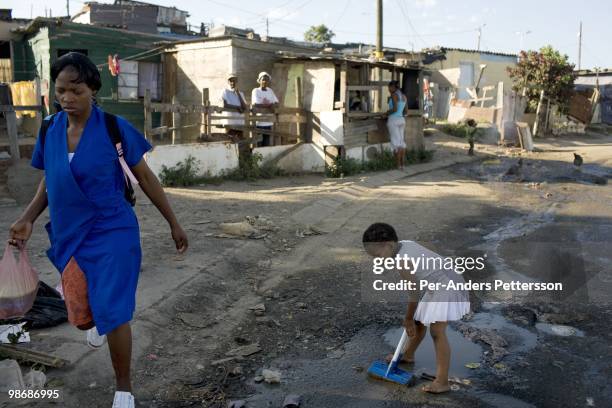 Child plays next to a garbage pile on March 10 in Duncan Village a poor township outside East London, South Africa. This area is one of the most...