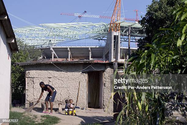 Villagers live in mud houses next the newly constructed World Cup 2010 stadium on February 19, 2009 in Nelspruit, South Africa. Nelspruit is one of...