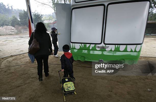 Boy accompanied by his mothers goes to his class on April 26, 2010 at the "bus school" where the private school Mis Sonidos is working following its...