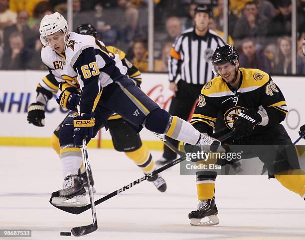 Tyler Ennis of the Buffalo Sabres jumps over the stick of David Krejci of the Boston Bruins and still hangs on to the puck in Game Six of the Eastern...