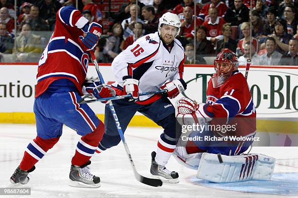 Eric Fehr of the Washington Capitals watches the rebounding puck in front of Jaroslav Halak of the Montreal Canadiens in Game Six of the Eastern...