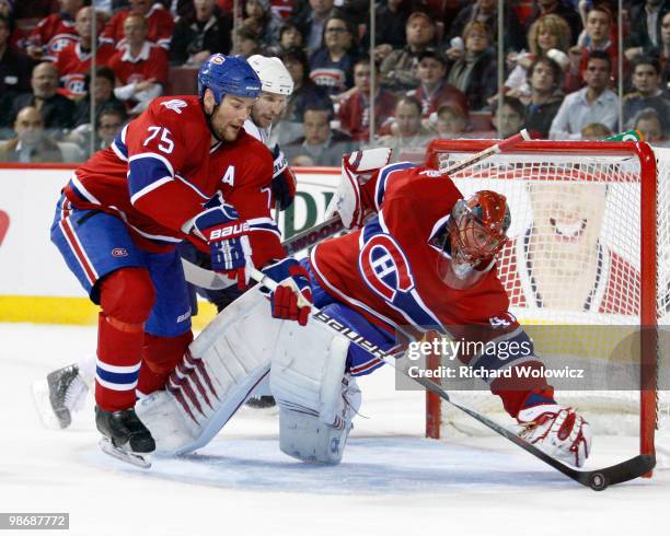 Hal Gill picks up the loose puck to the side of teammate Jaroslav Halak of the Montreal Canadiens in Game Six of the Eastern Conference Quarterfinals...