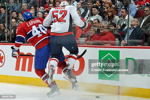 Maxim Lapierre of Montreal Canadiens collides with Mike Green of the Washington Capitals in Game Six of the Eastern Conference Quarterfinals during...