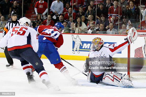Semyon Varlamov of the Washington Capitals stretches out to stop the puck on an attempt by Maxim Lapierre of the Montreal Canadiens in Game Six of...