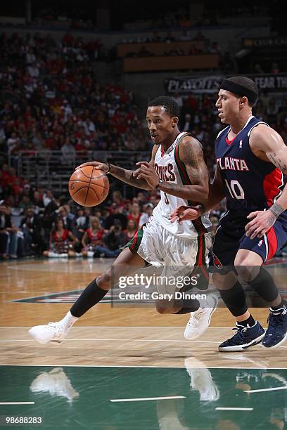 Brandon Jennings of the Milwaukee Bucks drives to the basket against Mike Bibby of the Atlanta Hawks in Game Four of the Eastern Conference...