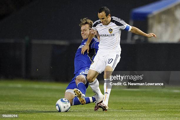 Michael Harrington of the Kansas City Wizards slides in to play the ball from Landon Donovan of the Los Angeles Galaxy during their MLS match on...