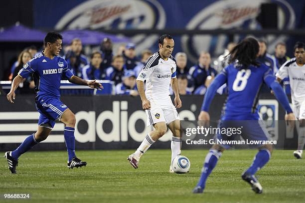 Landon Donovan of the Los Angeles Galaxy paces the ball against Roger Espinoza of the Kansas City Wizards during their MLS match on April 24, 2010 at...