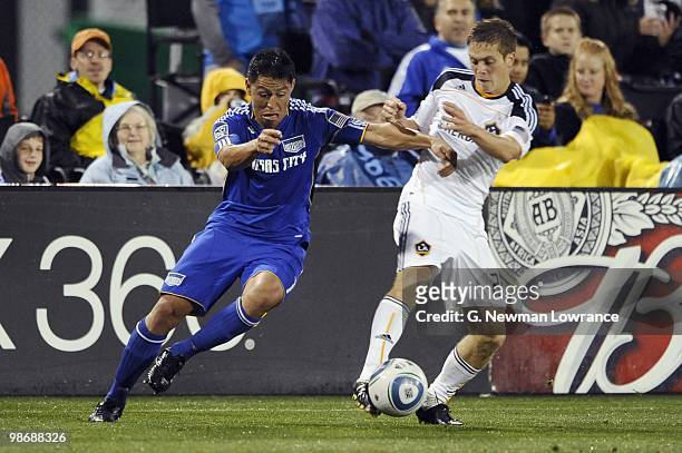 Michael Stephens of the Los Angeles Galaxy plays the ball under pressure from Roger Espinoza of the Kansas City Wizards during their MLS match on...