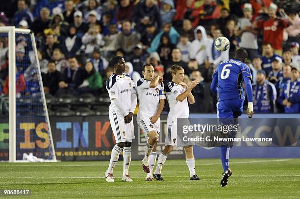 Edson Buddle, Landon Donovan and Michael Stephens of the Los Angeles Galaxy form the defensive wall during a free kick by Pablo Escobar of the Kansas...