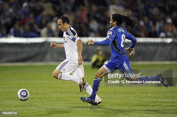 Landon Donovan of the Los Angeles Galaxy paces the ball under pressure from Stephane Auvray of the Kansas City Wizards during their MLS match on...