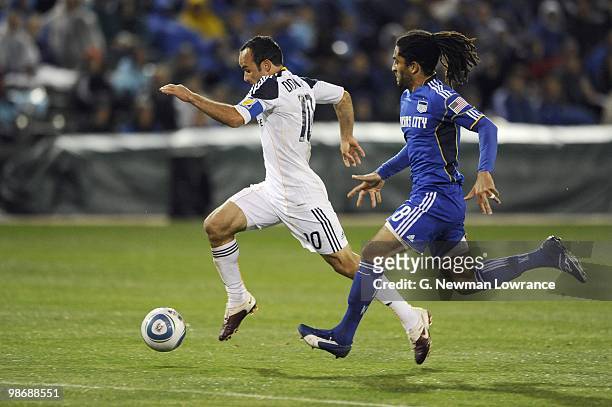Landon Donovan of the Los Angeles Galaxy paces the ball under pressure from Stephane Auvray of the Kansas City Wizards during their MLS match on...