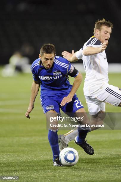 Davy Arnaud of the Kansas City Wizards under pressure from Chris Birchall of the Los Angeles Galaxy during their MLS match on April 24, 2010 at...