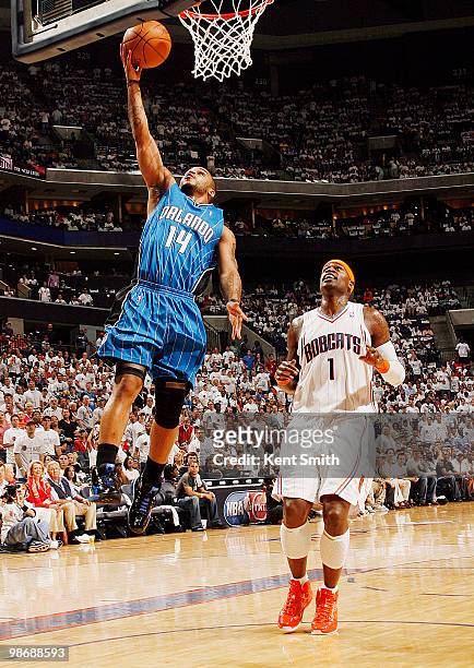Jameer Nelson of the Orlando Magic goes for the layup against Stephen Jackson of the Charlotte Bobcats in Game Four of the Eastern Conference...