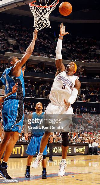 Gerald Wallace of the Charlotte Bobcats goes for the layup against Rashard Lewis of the Orlando Magic in Game Four of the Eastern Conference...