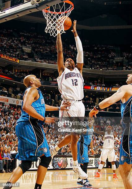 Tyrus Thomas of the Charlotte Bobcats goes for the layup against Vince Carter of the Orlando Magic in Game Four of the Eastern Conference...