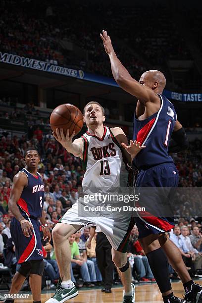 Luke Ridnour of the Milwaukee Bucks shoots a layup against Maurice Evans of the Atlanta Hawks in Game Four of the Eastern Conference Quarterfinals...