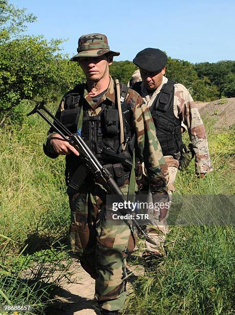 Policemen and soldiers search for left-wing guerrillas in the bushes of the department of Concepcion, Paraguay, on April 26, 2010. Paraguay's...