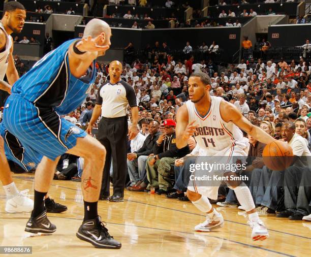 Augustin of the Charlotte Bobcats attempts to drive around defender Marcin Gortat of the Orlando Magic in Game Four of the Eastern Conference...