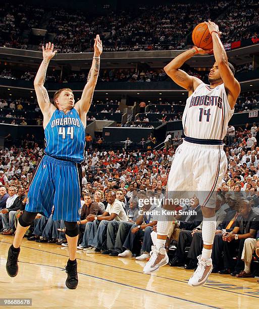 Augustin of the Charlotte Bobcats shoots over Jason Williams of the Orlando Magic in Game Four of the Eastern Conference Quarterfinals during the...