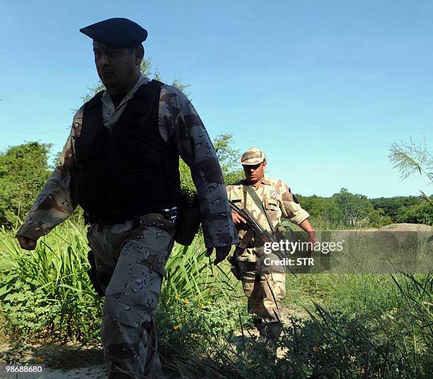 Policemen and soldiers search for left-wing guerrillas in the bushes of the department of Concepcion, Paraguay, on April 26, 2010. Paraguay's...