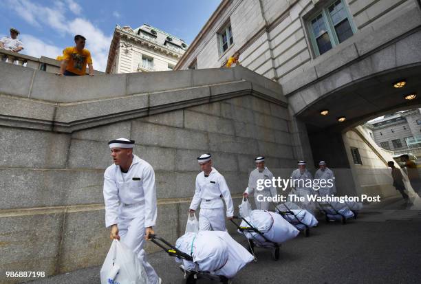 Incoming freshmen or plebes walk next to Bancroft Hall during Induction Day at the United States Naval Academy on Thursday June 28, 2018 in...