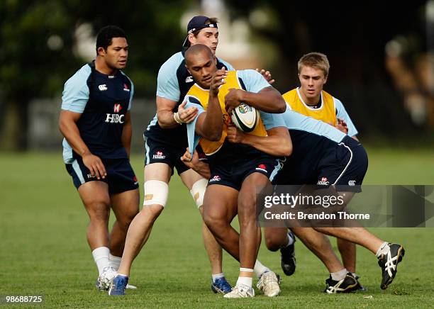 Nemani Nadolo is tackled during a Waratahs Super 14 training session at on April 27, 2010 in Sydney, Australia.