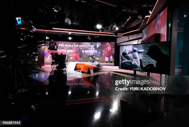 Picture taken on June 8, 2018 shows an unidentified anchor of the Russia Today TV company as he prepares to go on the air in their studio in Moscow.