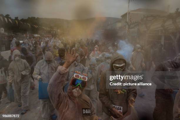 Febuary 2018, Greece, Galaxidi: people taking part in the color-laden ceremony on the occasion of Ash Monday pick up bags of flour at the beginning...