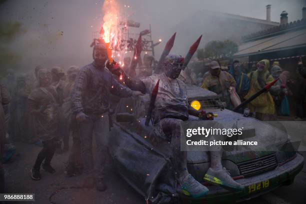 Dpatop - Revellers throw coloured powder at each other and carry lit flares during the celebrations of Ash Monday, which, according to Eastern...