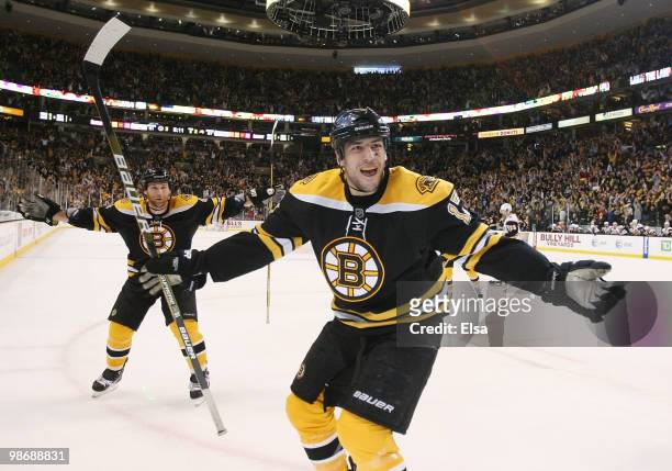 Milan Lucic and Dennis Wideman of the Boston Bruins celebrate teammate Miroslav Satan's game winning goal in the third period against the Buffalo...