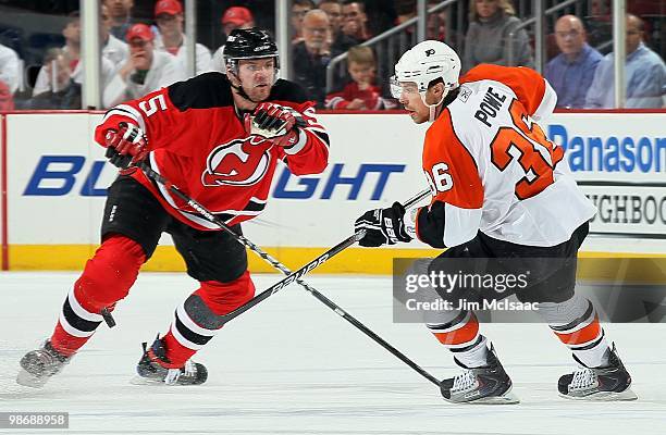 Darroll Powe of the Philadelphia Flyers skates against Colin White of the New Jersey Devils in Game 5 of the Eastern Conference Quarterfinals during...
