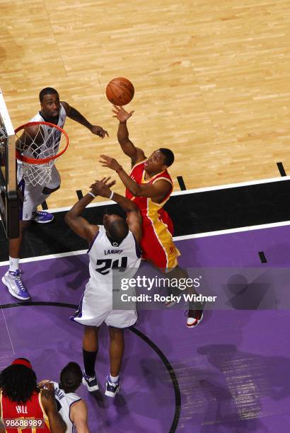 Kyle Lowry of the Houston Rockets shoots over Carl Landry of the Sacramento Kings at Arco Arena on April 12, 2010 in Sacramento, California. The...