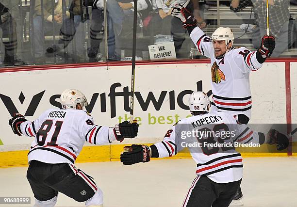 Marian Hossa, Tomas Kopecky, and Patrick Sharp of the Chicago Blackhawks celebrate after scoring a goal against the Nashville Predators in Game Six...