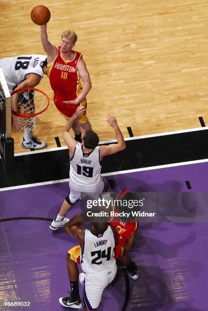 Chase Budinger of the Houston Rockets hooks a shot over Beno Udrih of the Sacramento Kings at Arco Arena on April 12, 2010 in Sacramento, California....