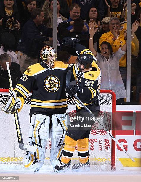 Tuukka Rask and Patrice Bergeron of the Boston Bruins celebrate the win over the Buffalo Sabres in Game Six of the Eastern Conference Quarterfinals...